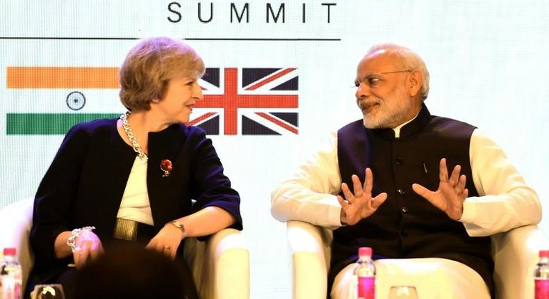 British Prime Minister Theresa May speaks with India's counterpart Narendra Modi as they attend The India-UK Tech Summit in New Delhi, on November 7, 2016