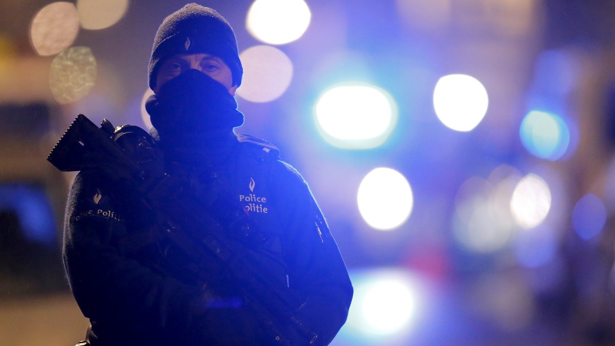 A masked Belgian police officer takes part in police operations in Schaerbeek