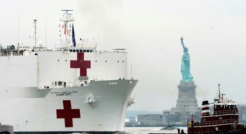 The USNS Comfort medical ship moves up the Hudson River past the Statue of Liberty as it arrives on March 30, 2020 in New York