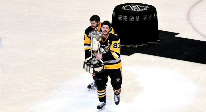 Sidney Crosby (R) and Chris Kunitz of the Pittsburgh Penguins celebrate with the Prince of Wales Trophy after winning Game Seven of the NHL Eastern Conference Finals against the Ottawa Senators, in Pittsburgh, Pennsylvania, on May 25, 2017