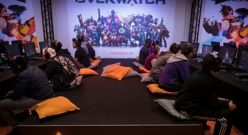 Visitors play the video game Overwatch at the 2016 Paris Games Week. Game developer Activision is creating an eSports league around the game