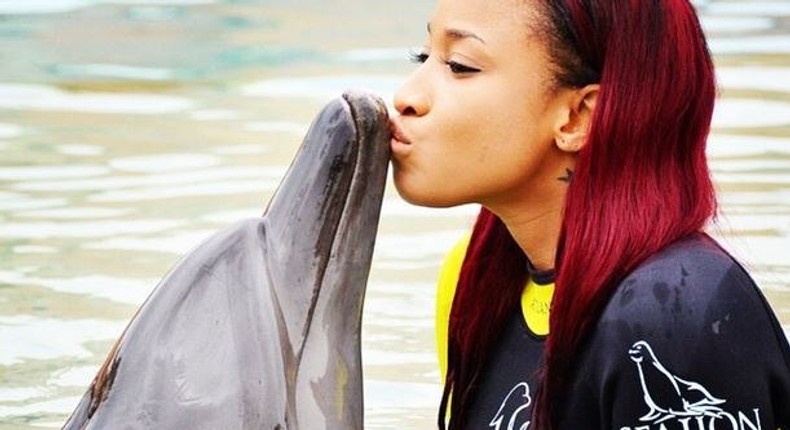 Tonto Dikeh kissing a dolphin