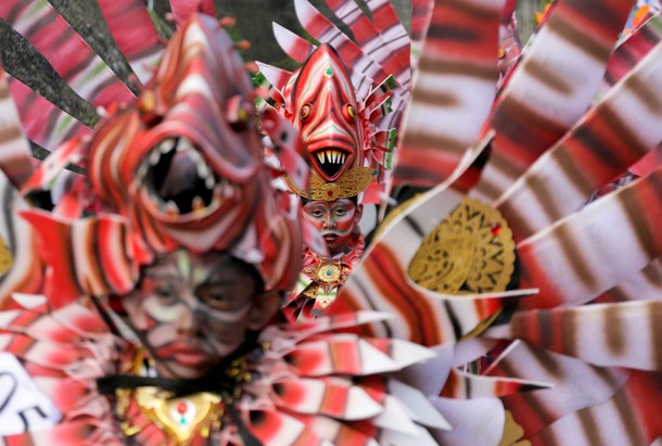 Balinese artists dressed in decorative costumes take part in the Maritime Festival at Pandawa Beach 