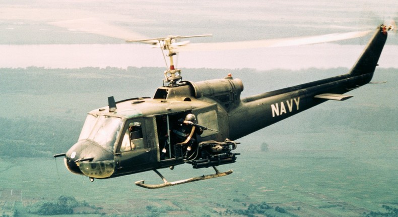 The door gunner in a UH-1B Huey gunship fires on Vietcong positions during a search-and-destroy mission in the Mekong Delta, January 23, 1968.