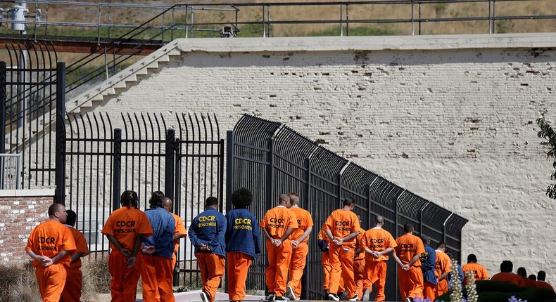 In this Aug. 16, 2016, file photo, general population inmates walk in a line at San Quentin State Prison in San Quentin, Calif.
