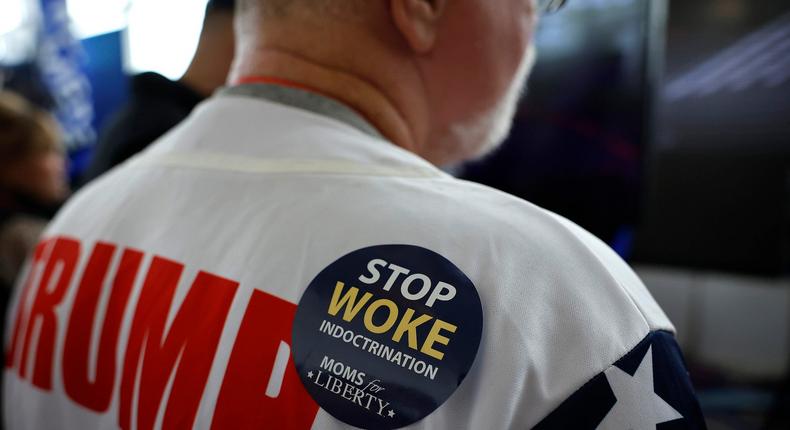 A man wears a Stop Woke Indoctrination sticker at CPAC 2023.Chip Somodevilla/Getty Images
