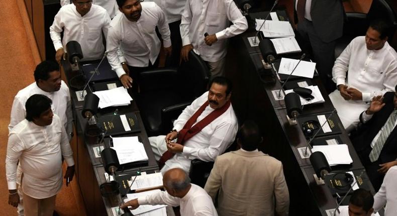 A majority of Sri Lanka's parliament supported a no-confidence motion against former president and currently appointed prime minister, Mahinda Rajapakse (C)