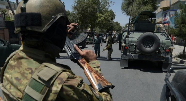 Security forces arrive at the site of a suicide blast near Iraq's embassy in Kabul