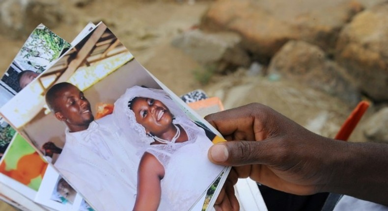 James Harris with photographs of his wife, Salome Karwah. He says nurses refused to touch her because she was an Ebola survivor