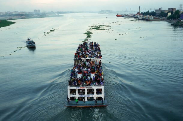 A ferry with passengers traveling home to celebrate Eid al-Fitr festival leaves Dhaka