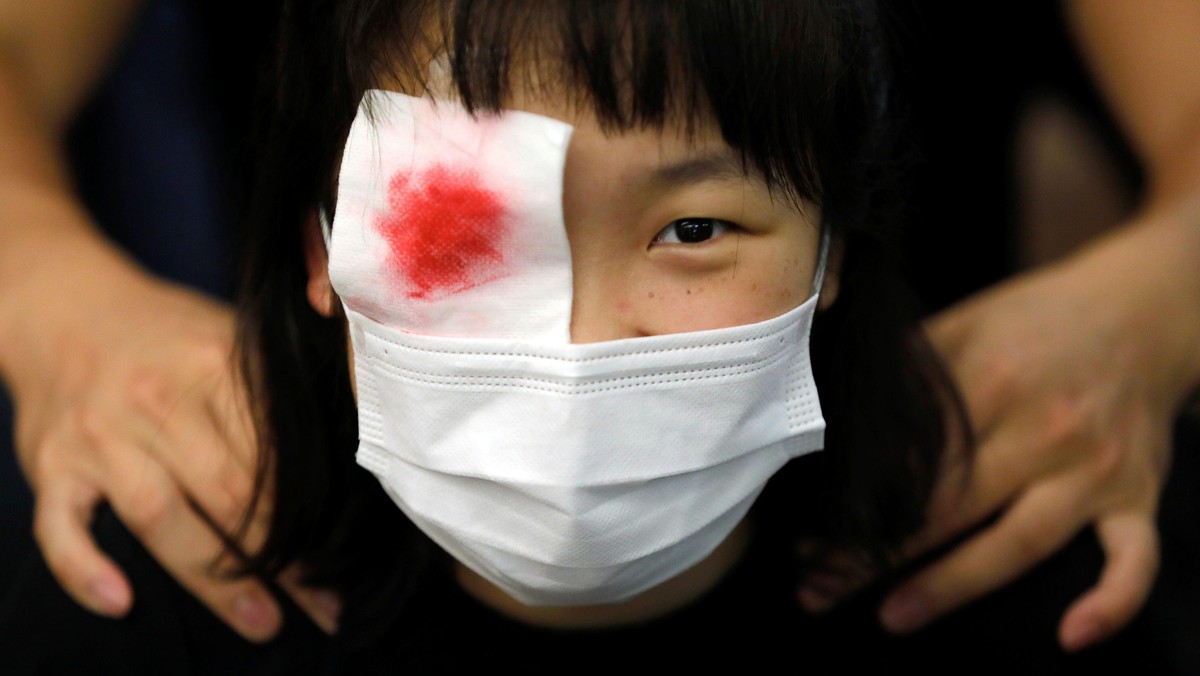 Protest at Yuen Long MTR station, the scene of an attack by suspected triad gang members a month ago, in Hong Kong