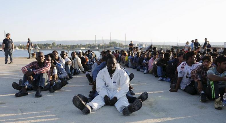 Migrants rest after disembarking in the Sicilian harbour of Augusta, Italy, June 23, 2015.   REUTERS/Antonio Parrinello