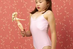 Young girl mimicking dolls figure