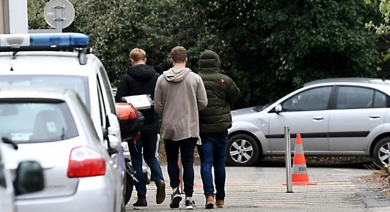 Players of the FC Grenoble rugby team arrive on March 22, 2017 at the police station in Grenoble to be heard as part of an investigation for rape