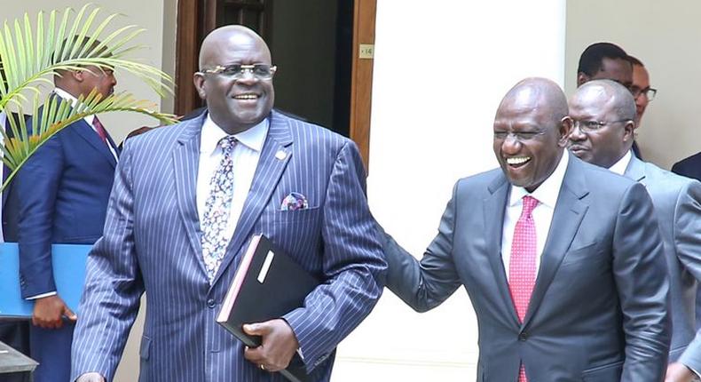 President William Ruto shares a light moment with former CS George Magoha