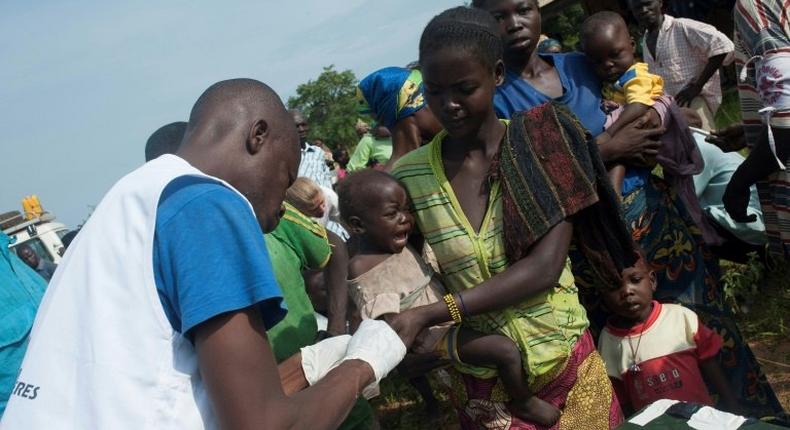 Members of the NGO Doctors Without Borders distribute medicine against malaria on the outskirts of Bambari, in 2014