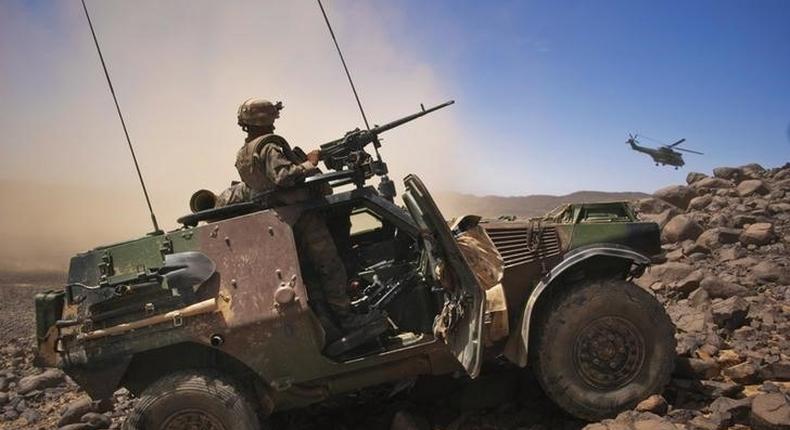 A French soldier stands guard in an armoured vehicle , about 60 km (37 miles) south of the town of Tessalit in northern Mali March 21, 2013. 