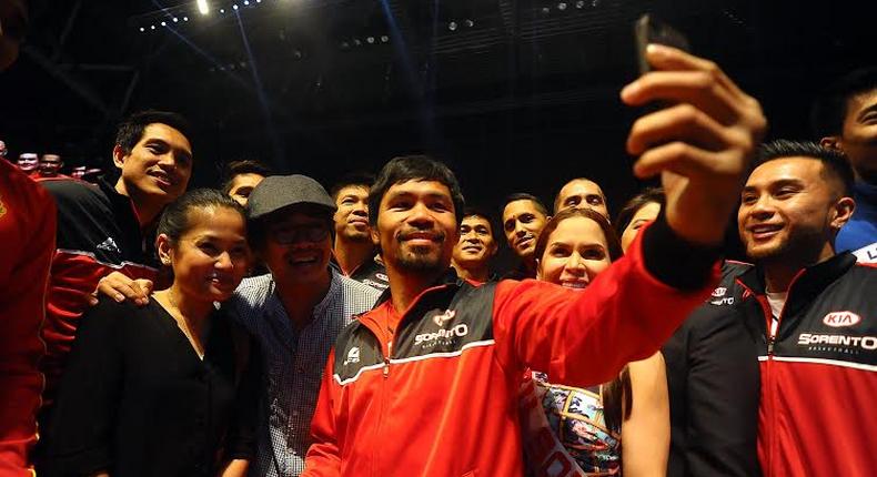 Manny Pacquiao taking a selfie with fans and team before the fight