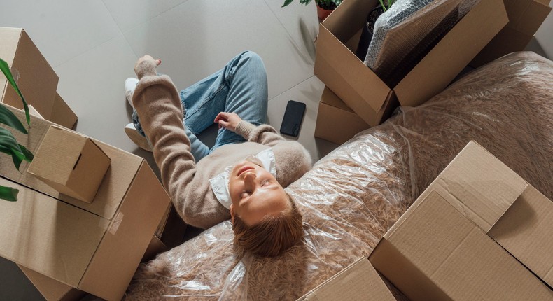 A woman takes a break from the burden of packingWestend61/Getty Images