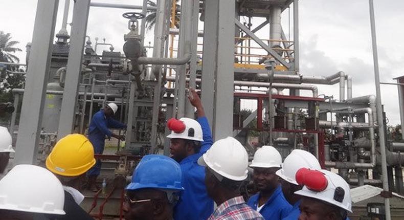 Workers at a refinery (File Photo)