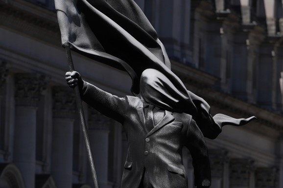 (FOTO, VIDEO) Osvanula antiimperijalistička Benksijeva statua: Čovek na vlasti, kome zastava u potpunosti zaklanja vid, korača i samo što ne padne sa postolja