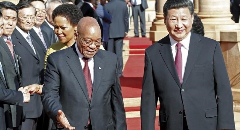 Chinese President Xi Jinping walks with South African President Jacob Zuma upon his arrival at the Union Buildings in Pretoria , December 2, 2015. REUTERS/Sydney Seshibedi