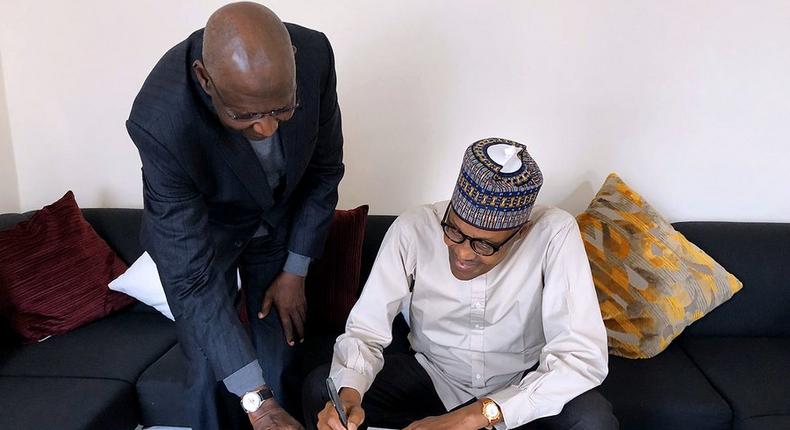 President Muhammadu Buhari signs Deep Offshore bill into law in London, with Chief of Staff Abba Kyari (Twitter: @BashirAhmaad) 