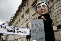 Protestor wearing a Theresa May mask is seen the day after Britain's election in London