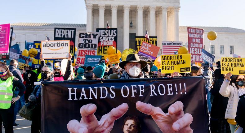 Stephen Parlato of Boulder, Colo., holds a sign that reads Hands Off Roe!!! as abortion rights advocates and anti-abortion protesters demonstrate in front of the U.S. Supreme Court, Wednesday, Dec. 1, 2021.