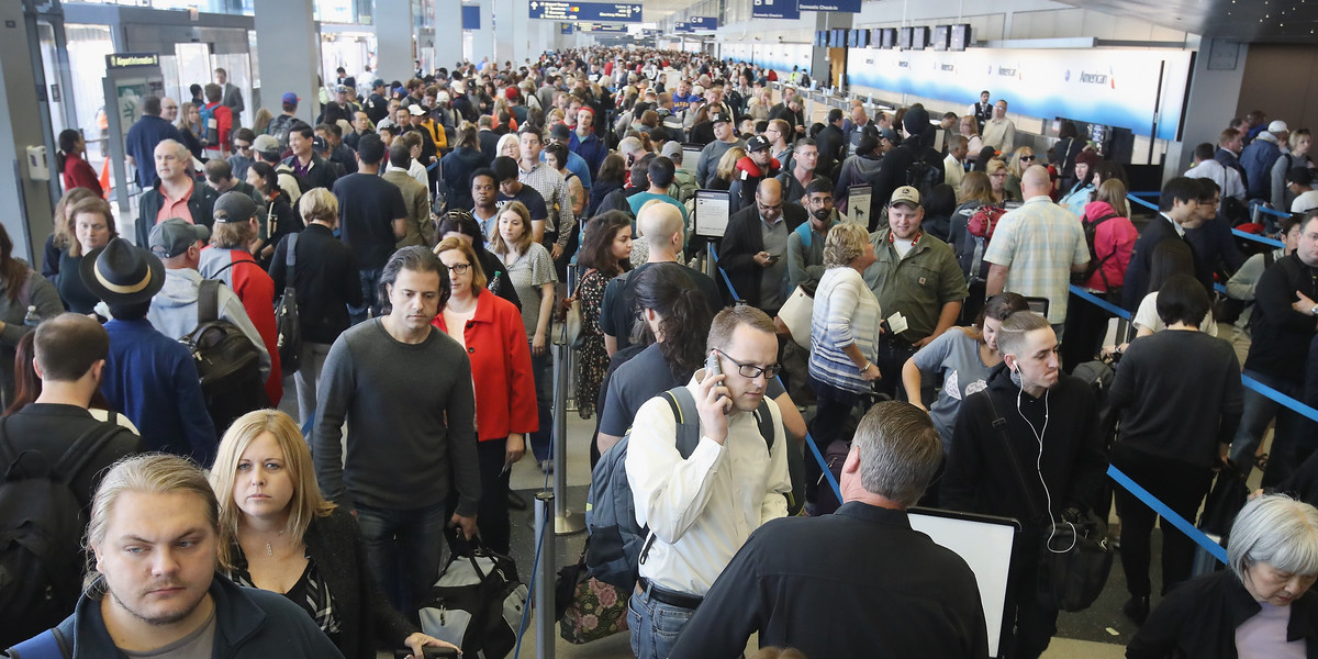 Passengers at O'Hare International Airport, in Chicago, wait in line to be screened at a TSA checkpoint.