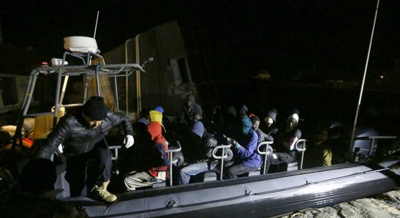 Libyan coastguards help migrants who were rescued at sea off the coast of Tripoli, on February 5, 2017