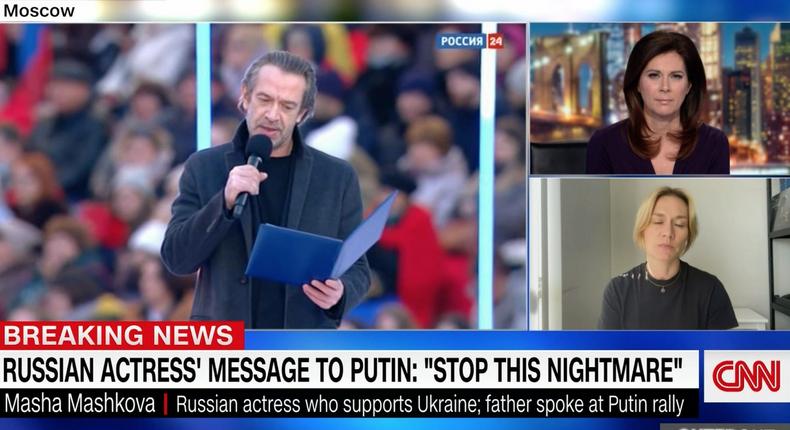 Masha Mashkova speaks on CNN alongside footage of her dad at the pro-war rally in Moscow.