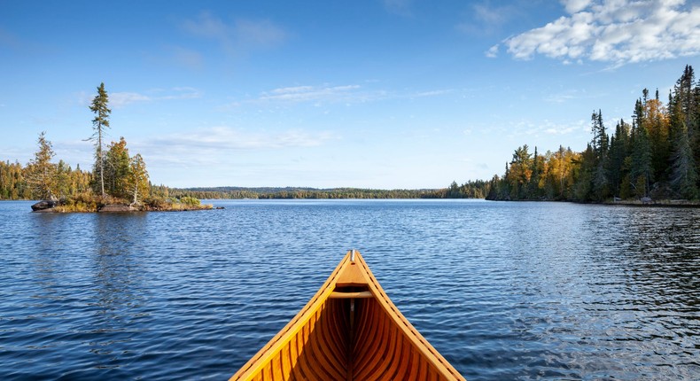 A wooden canoe in a lake.Willard/Getty Images.