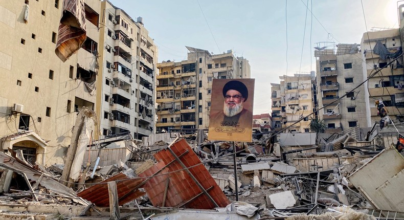 Israel has targeted Hezbollah's key figures in a bid to dismantle the group. A portrait of slain Hezbollah leader Hassan Nasrallah sits amid debris in Beirut.-/AFP via Getty Images