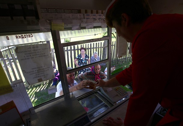 Villagers gather at the Belarusian Republican Union of Consumer Societies' mobile shop to buy produc