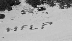 The crew of a Hawaii-based HC-130J Hercules aircraft makes contact with three mariners stranded on Pikelot Atoll, Yap State, Federated States of Micronesia, after dropping them a radio on April 8, 2024.US Coast Guard photo