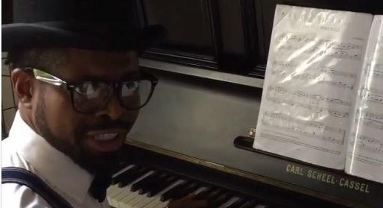 Basketmouth playing the piano