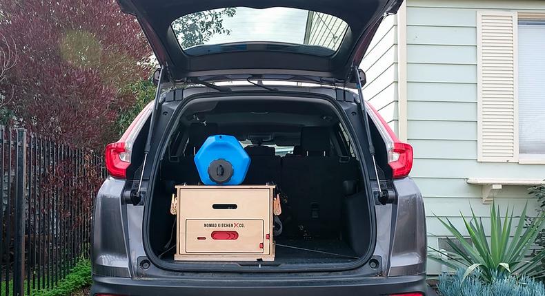 The cooking unit is stored in a box and can be slid out into a portable kitchen.