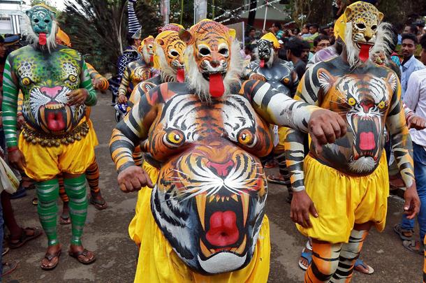 Performers painted to look like tigers dance during festivities marking the start of the annual harv