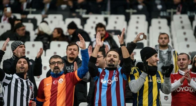 Besiktas, Fenerbahce, Galatasaray and Trabzon's supporters cheer prior to the Ziraat Turkish Cup football match between Besiktas and Kayserispor on December 14, 2016 at Vodafone arena stadium, in Istanbul
