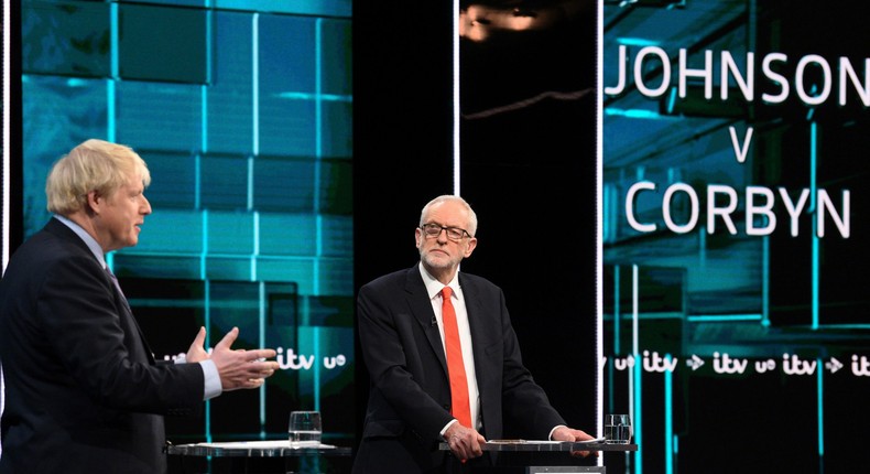 In this photo issued by ITV, Jeremy Corbyn, right, and Boris Johnson, during the election head-to-head debate live on TV, in Salford, Manchester, England, Tuesday, Nov. 19, 2019.  Prime Minister Boris Johnson and leader of the opposition Labour Party Jeremy Corbyn are set to go head-to-head in their first live televised debate Tuesday evening, as the UK prepares for a General Election on Dec. 12. (ITV via AP)