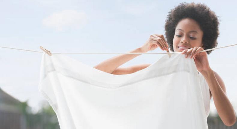 Woman hanging white laundry