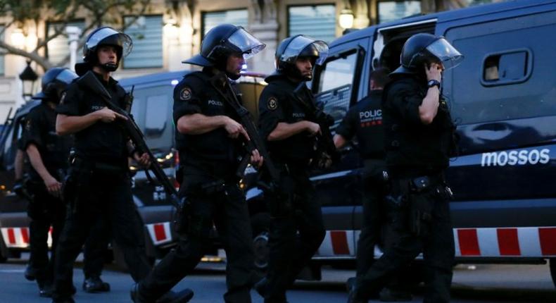 Spanish police cordon off Las Ramblas avenue in central Barcelona after a van ploughed into a crowd, killing 13 people on August 17, 2017