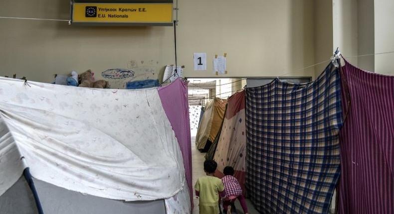 Children play in a corridor at the former Hellinikon airport turned into a refugee camp, near Athens, on March 30, 2017