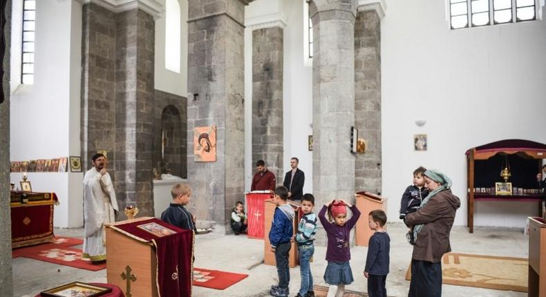 Father Nenad Stojanovic leads the Sunday mass on May 7, 2017 in the town of Mitrovica at St. Sava church in the Albanian part of a city that is sharply divided along ethnic lines