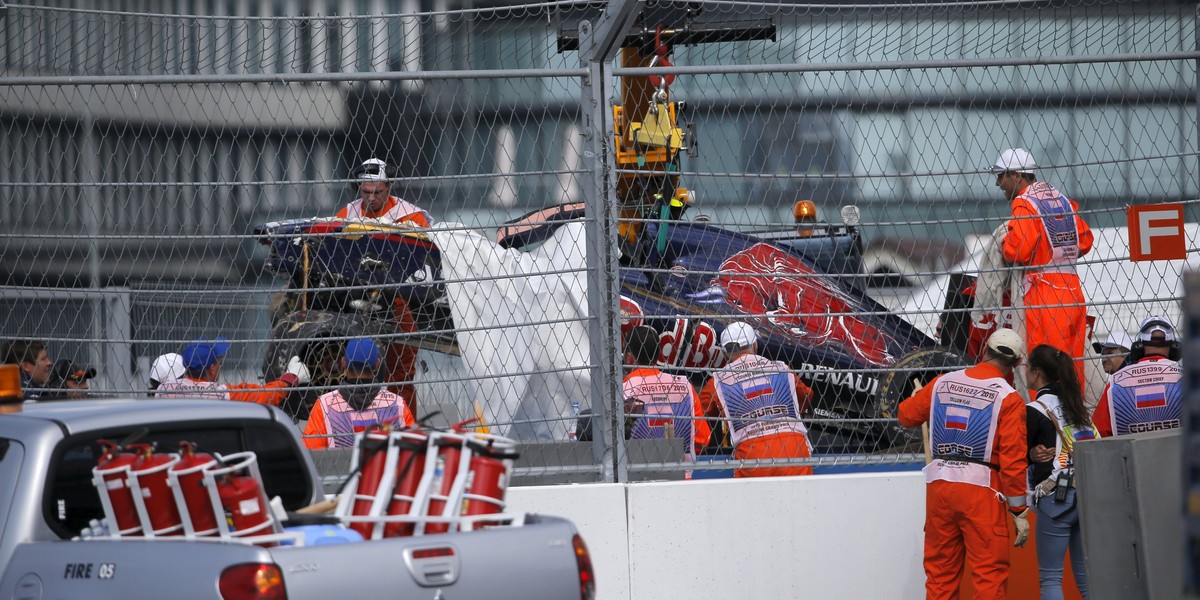 Marshals load the damaged car of Toro Rosso Formula One driver Carlos Sainz of Spain on a truck after he crashed during the third practice session ahead of the Russian F1 Grand Prix in Sochi