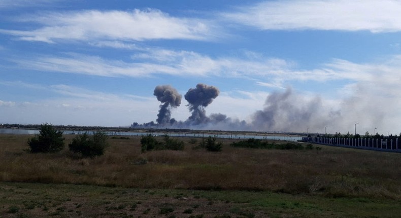 Smoke rises after explosions at a Russian air base near Novofedorivka in Crimea on August 9.