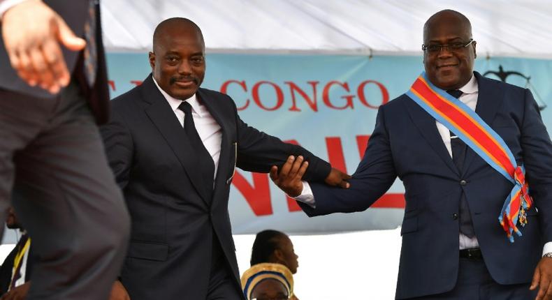 During his inauguration DR Congo's new president, Felix Tshisekedi, (R) walks off the podium with outgoing leader Joseph Kabila in Kinshasa in January 2019