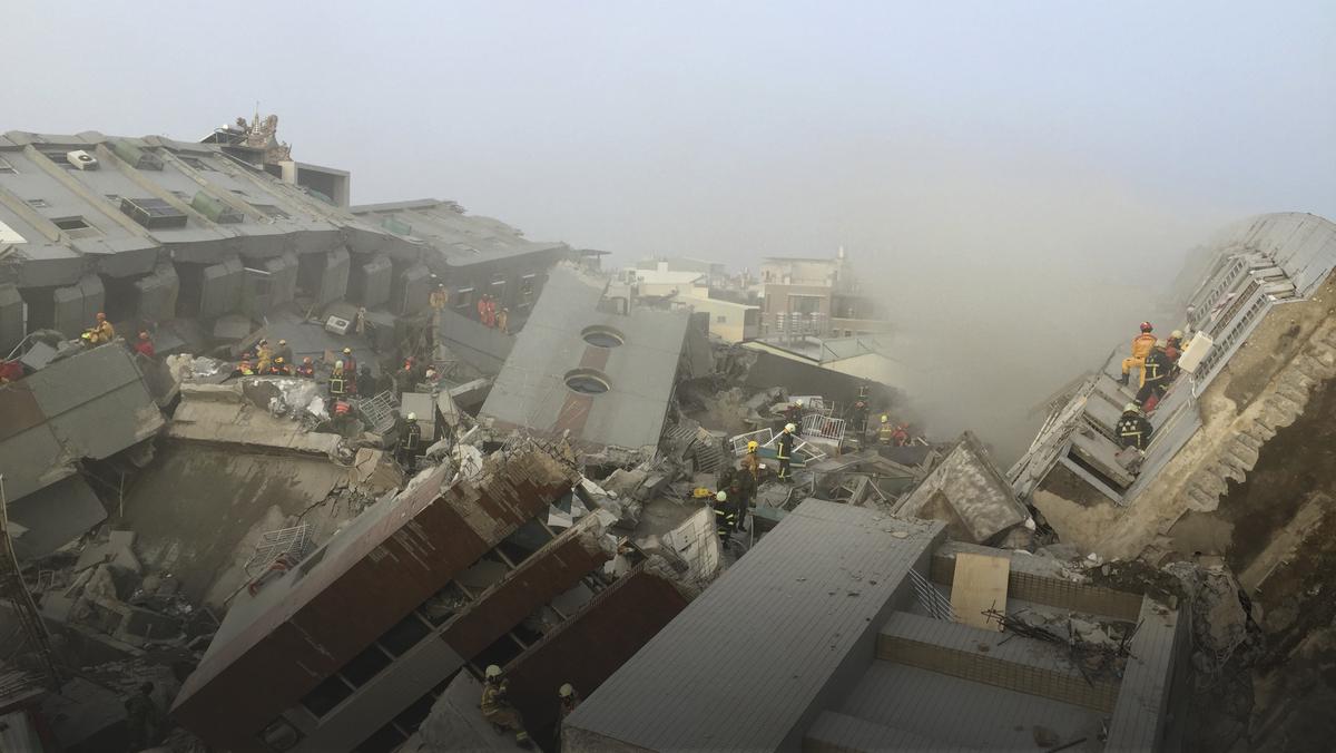 Rescue personnel work at the site where a 17-storey apartment building collapsed, after an earthquake in Tainan