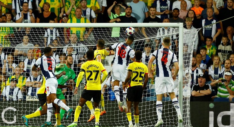 Karlan Grant heads at goal for West Brom against Watford as Emmanuel Dennis watches on.